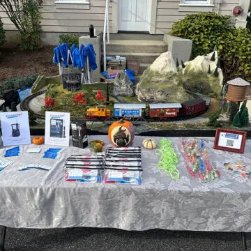 Community event table with Halloween decorations and giveaway items